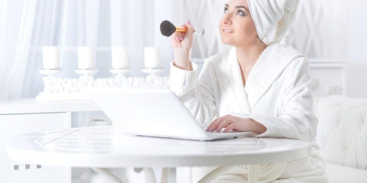 young-woman-using-laptop-applying-make-up_484921-29502